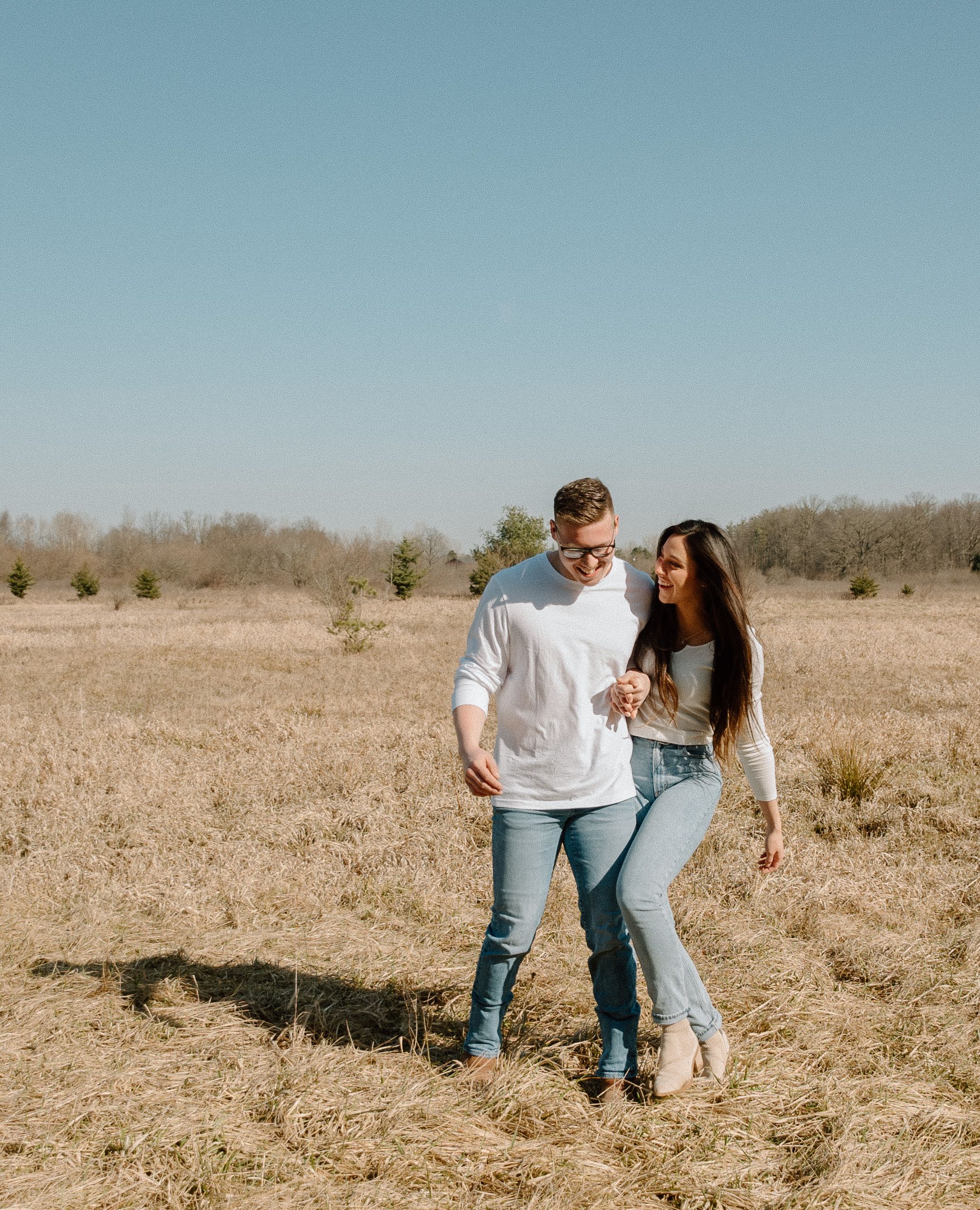 engagement session in open field in Capac Michigan