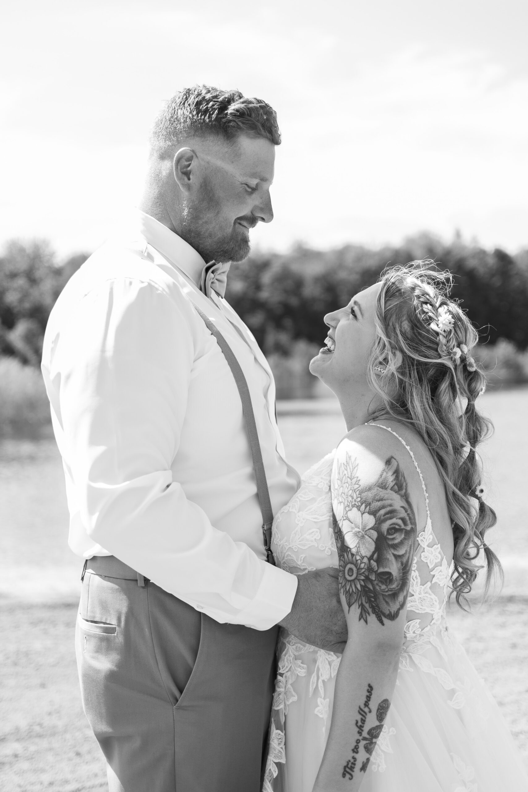 bride and groom laughing together on beach in Kimball Michigan