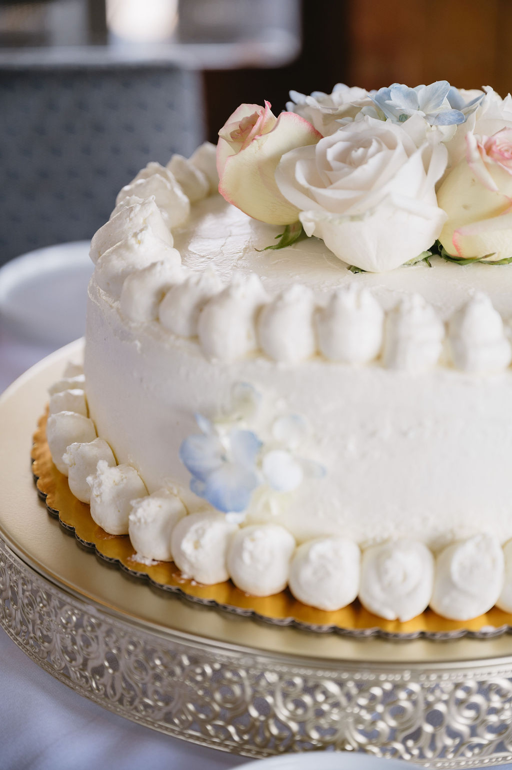 photo of white wedding cake with white roses at The River Crab, a restaurant in St Clair Michigan