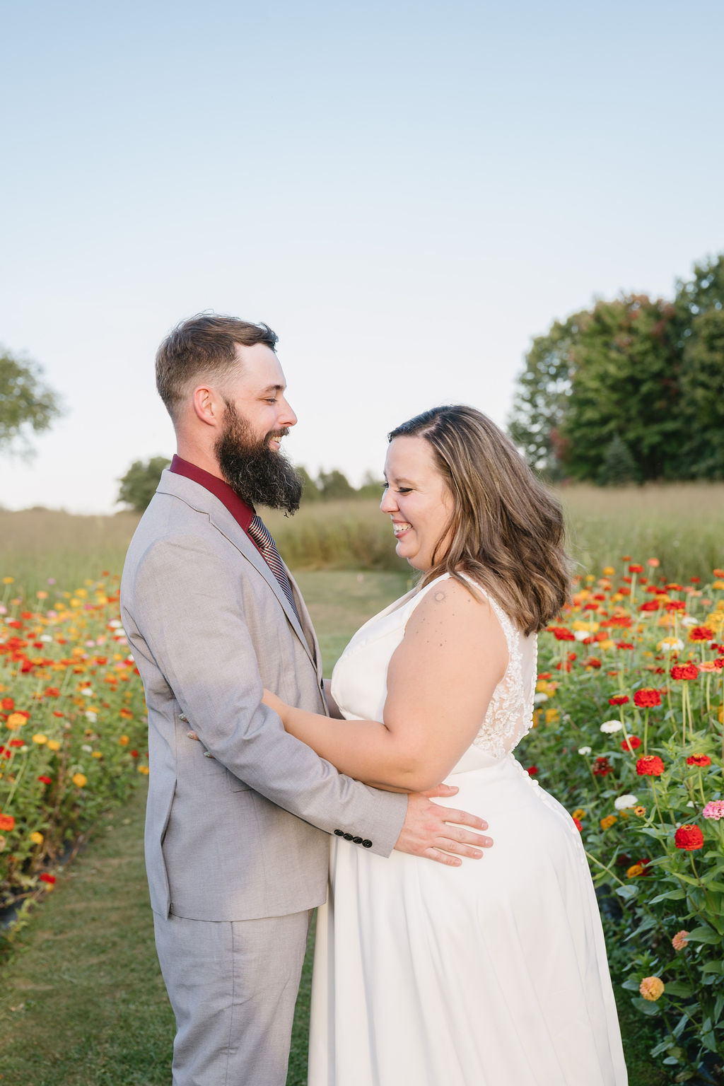 bride and groom laughing in flower farm