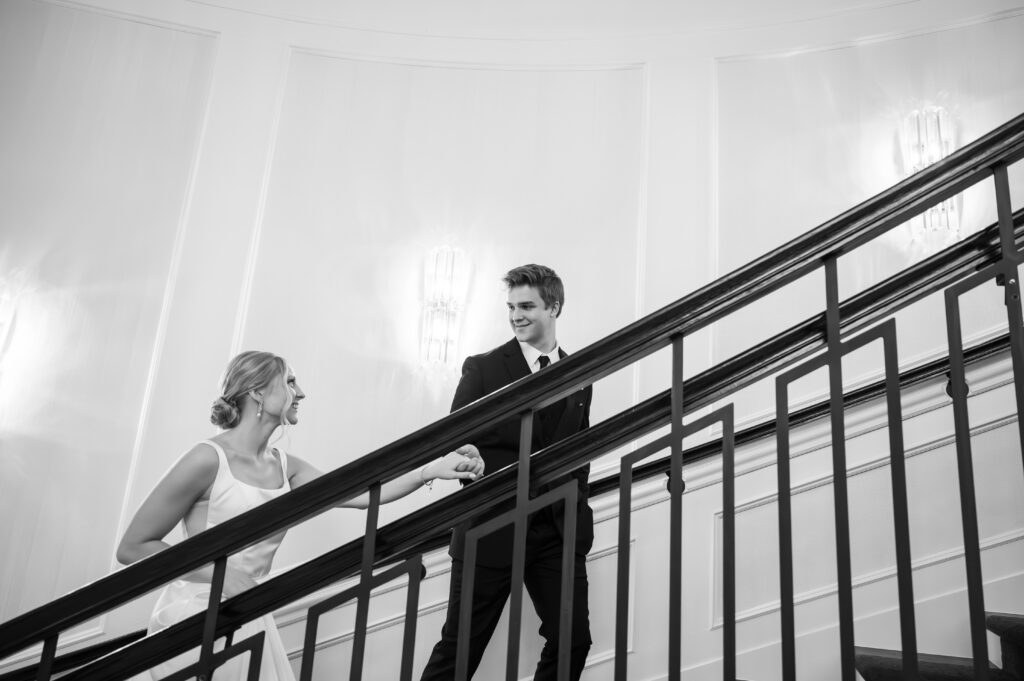 bride and groom walking up grand staircase at The Palazzo Grande, a wedding venue in Sterling Heights Michigan