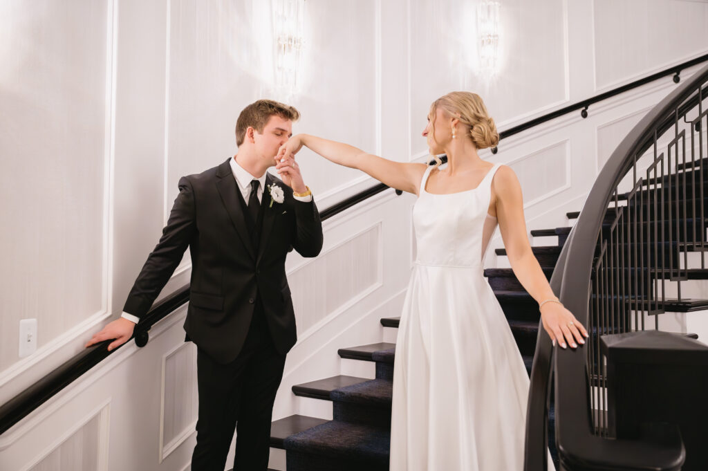 groom kissing bride's hand in The Palazzo Grande, a wedding venue in Sterling Heights Michigan