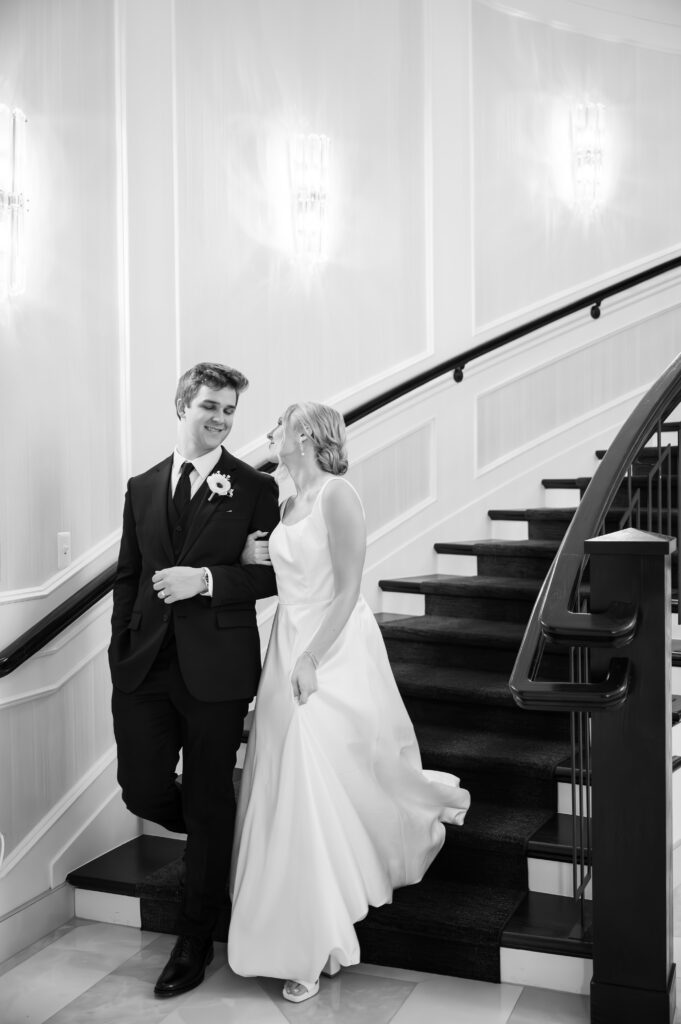 bride and groom walking down grand staircase at The Palazzo Grande, a Sterling Heights Michigan wedding venue