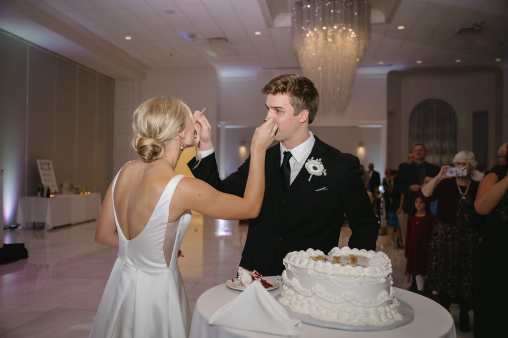 bride and groom cutting wedding cake at The Palazzo Grande, a wedding venue in Sterling Heights Michigan