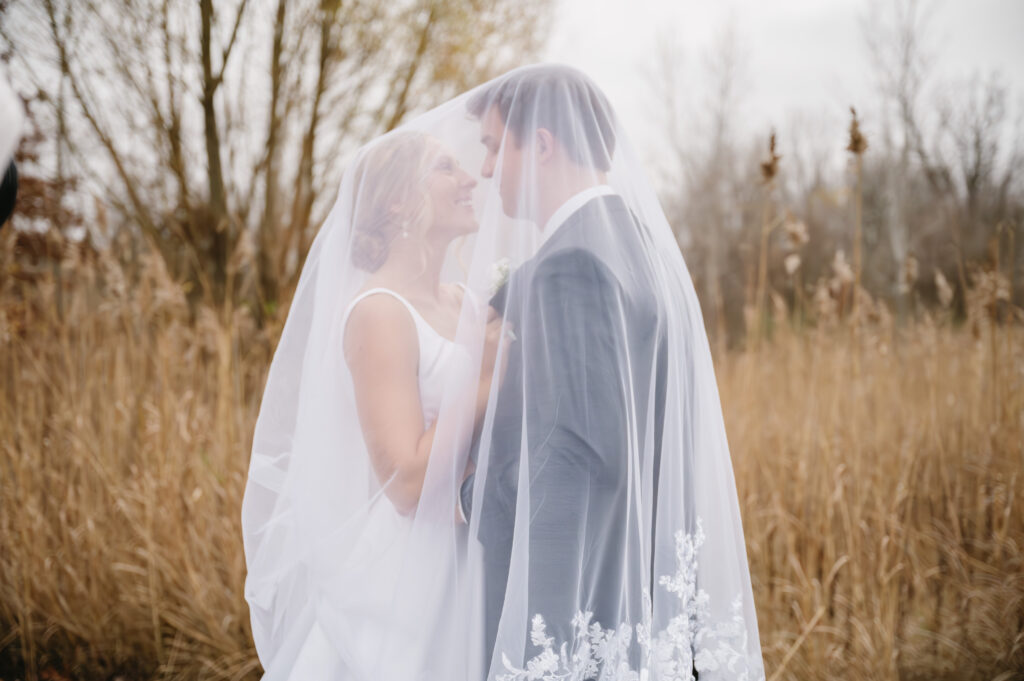 bride and groom under veil at The Palazzo Grande, a wedding venue in Sterling Heights Michigan