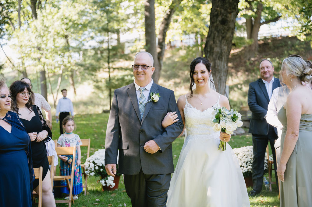 dad walking bride down aisle at outdoor wedding ceremony