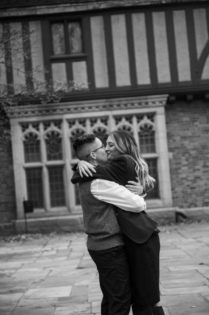 engaged couple kissing outside of Meadowbrook Hall, a wedding venue in Rochester Michigan