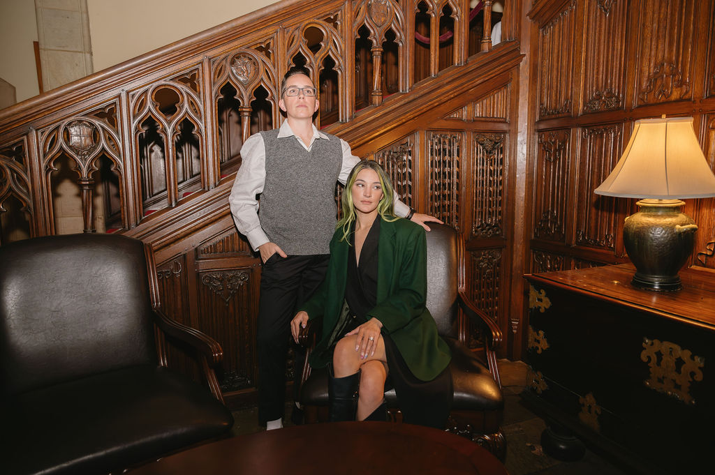 engaged couple sitting inside foyer of Meadowbrook Hall, a Rochester Michigan wedding venue