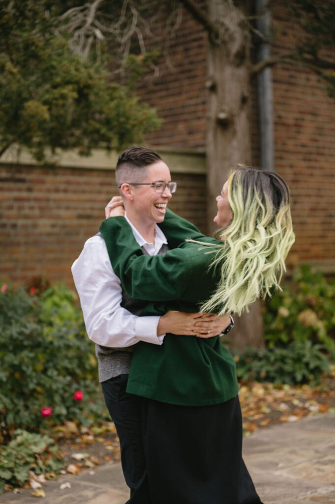 engaged couple spinning outside Meadowbrook Hall, a Rochester Michigan wedding venue