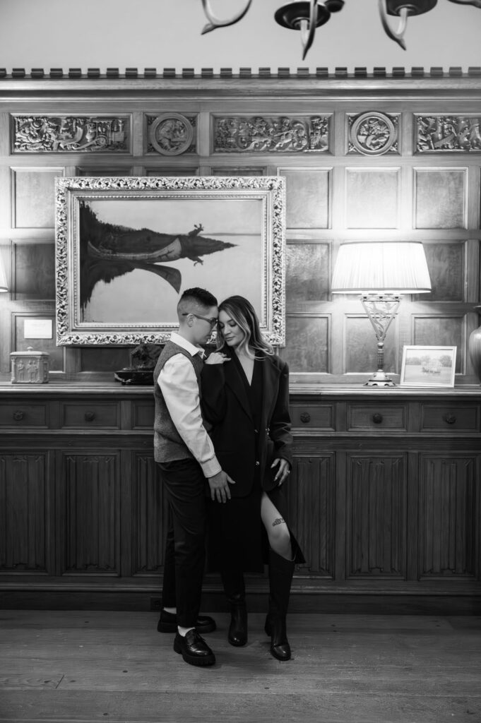 engaged couple standing inside study of Meadowbrook Hall, a Rochester Michigan wedding venue