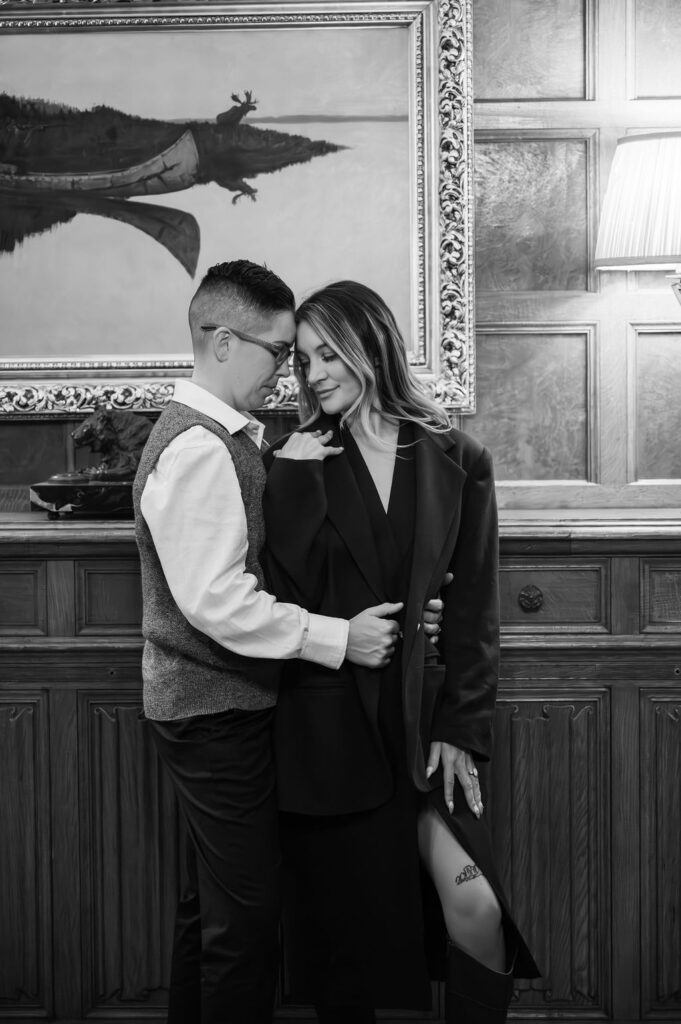 engaged couple standing inside study of Meadowbrook Hall, a Rochester Michigan wedding venue