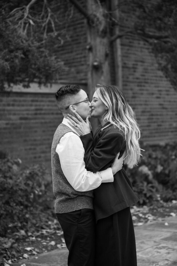 engaged couple kissing outside of Meadowbrook Hall, a wedding venue in Rochester Michigan