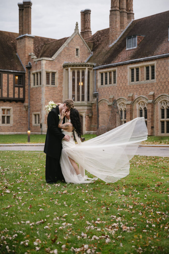 couple hugging in front of estate wedding venue