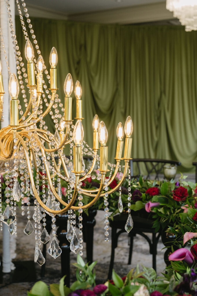 gold chandelier hanging near wedding reception tables