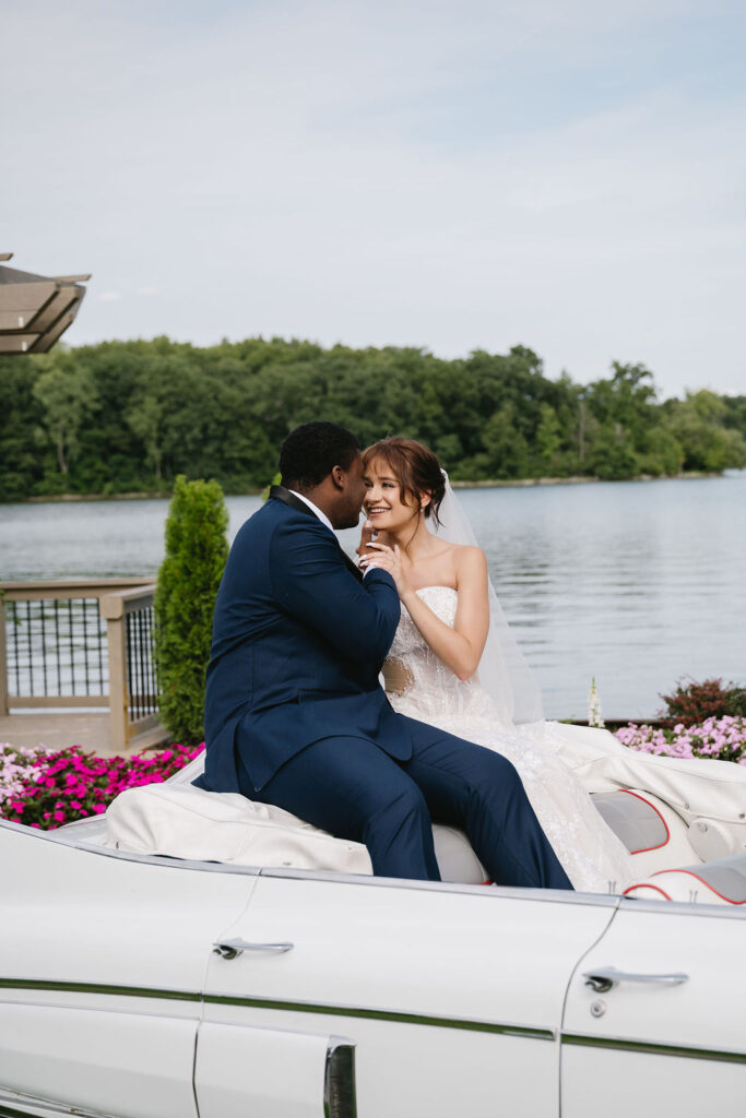 bride and groom sitting in vintage car