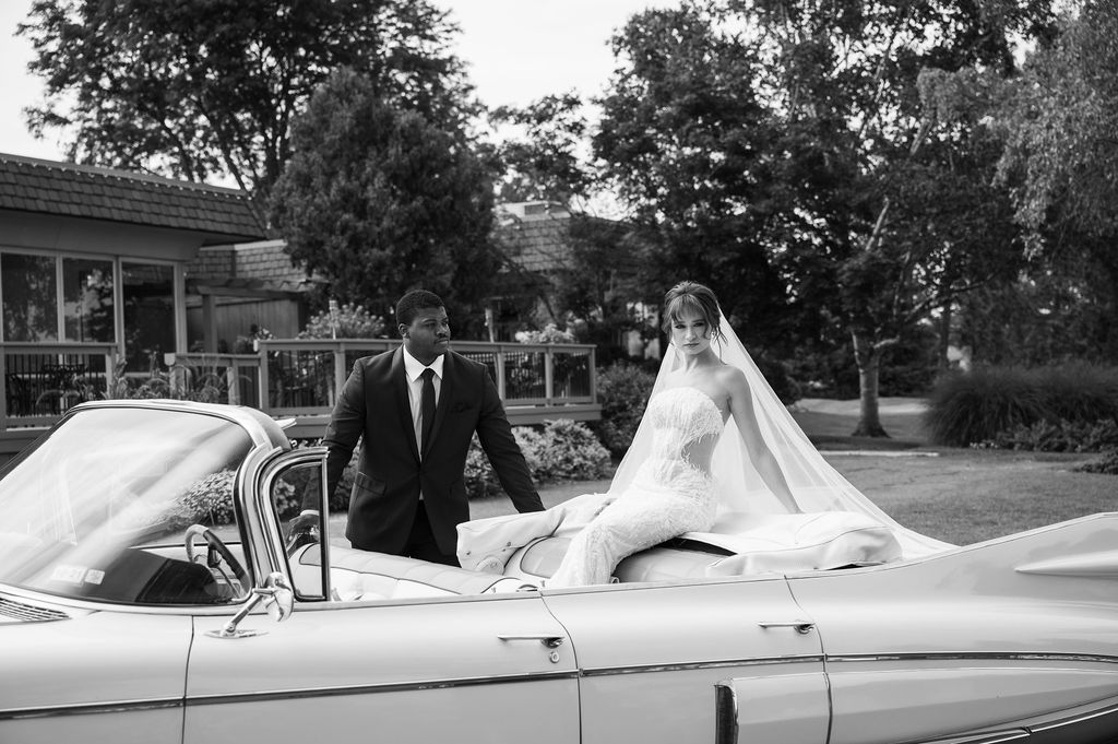 bride sitting in vintage car outside of southeast michigan golf club wedding venue