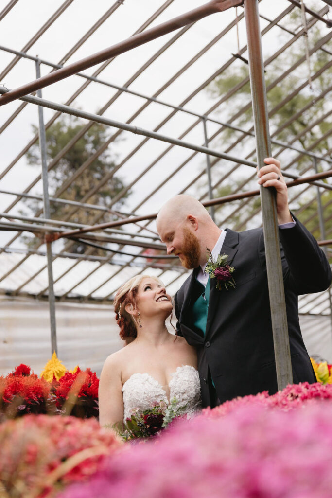 bride and groom portrait in greenhouse