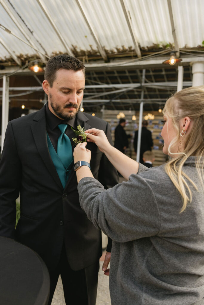 woman pinning boutonnière