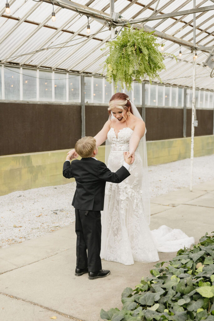 bride and son first look in greenhouse