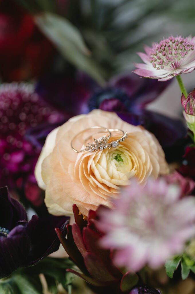 wedding rings on purple and yellow flowers