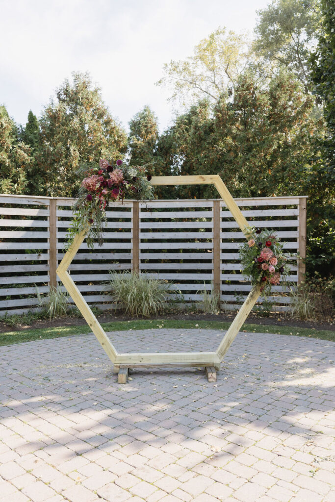 red & pink florals on wedding arch