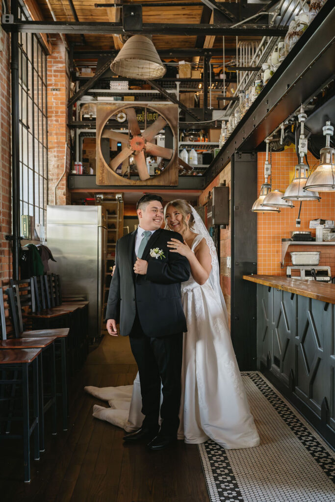 bride and groom smiling inside cork and gable, a metro detroit wedding venue