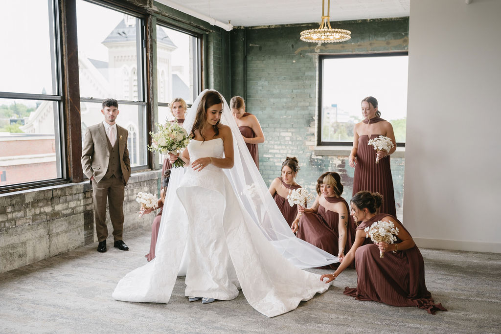 bridesmaids helping bride