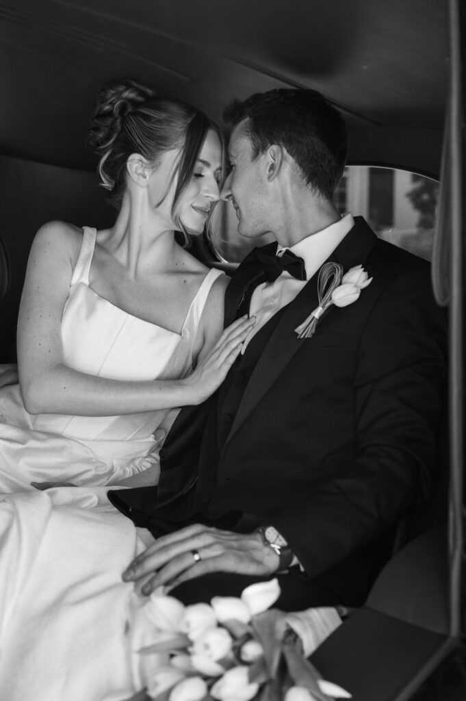 bride and groom inside black vintage car