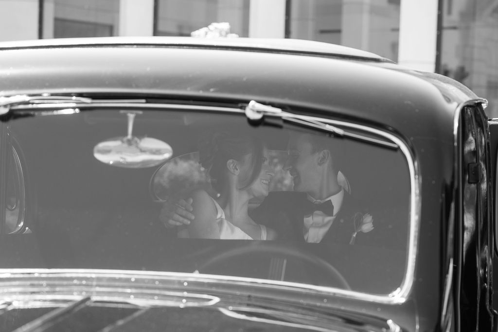 bride and groom inside vintage car