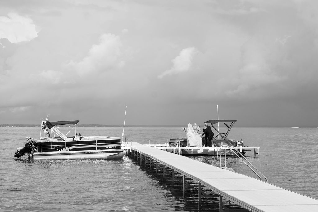 bride getting off boat on lake