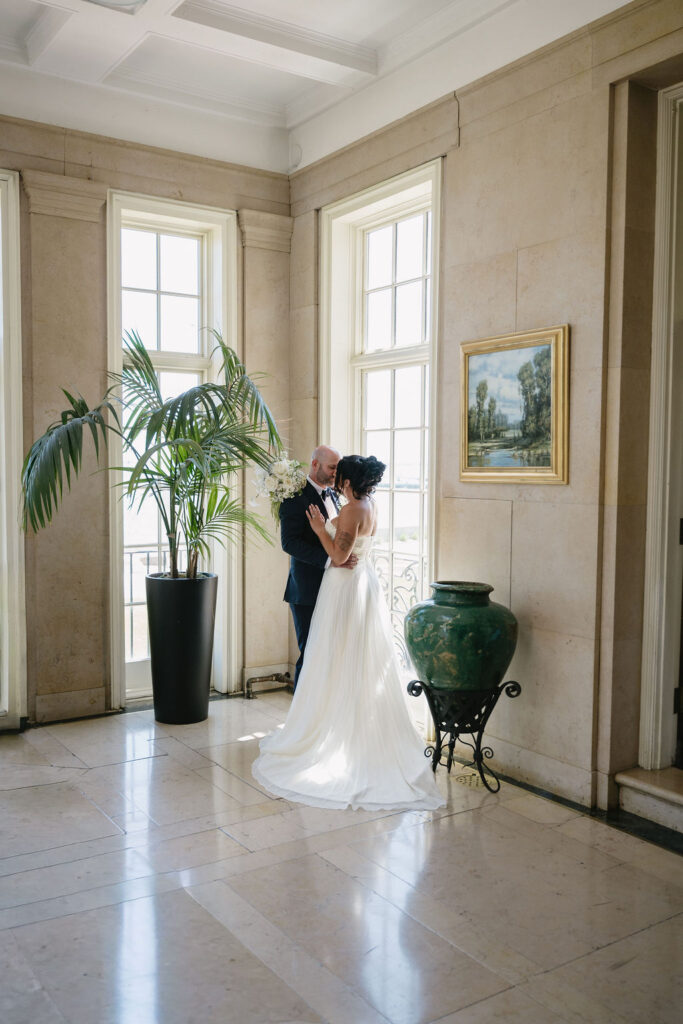 bride and groom standing in window