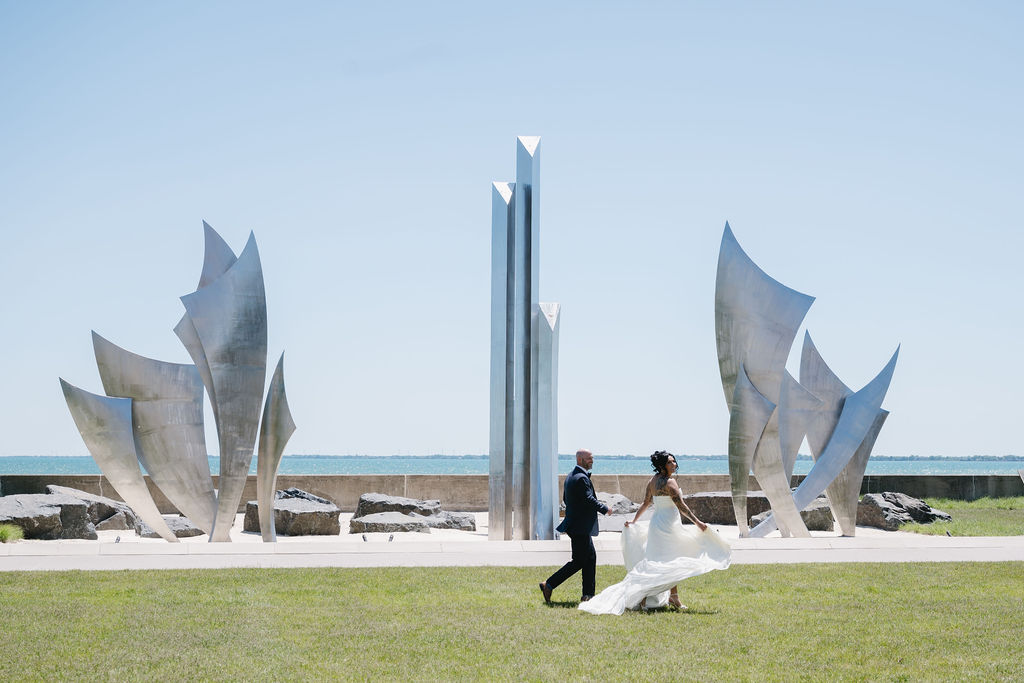 bride and groom walking by lake