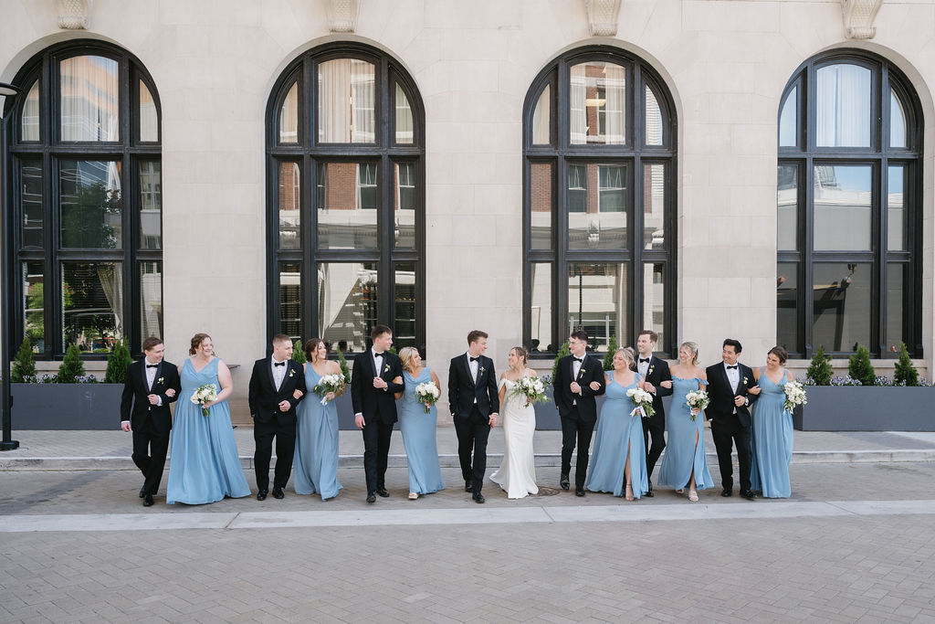 wedding party walking outside of amway grand hotel