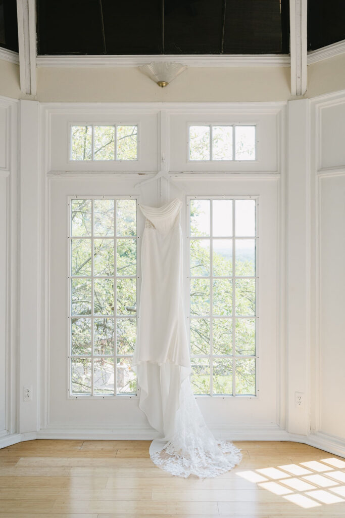 wedding gown hanging in bridal suite