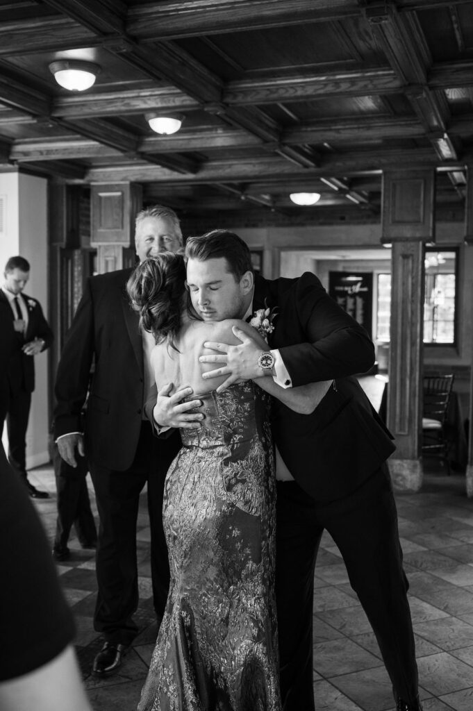 groom hugging mom