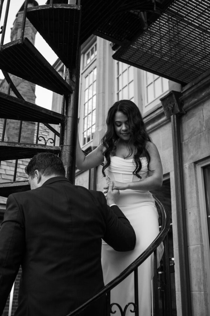 bride and groom walking down spiral staircase