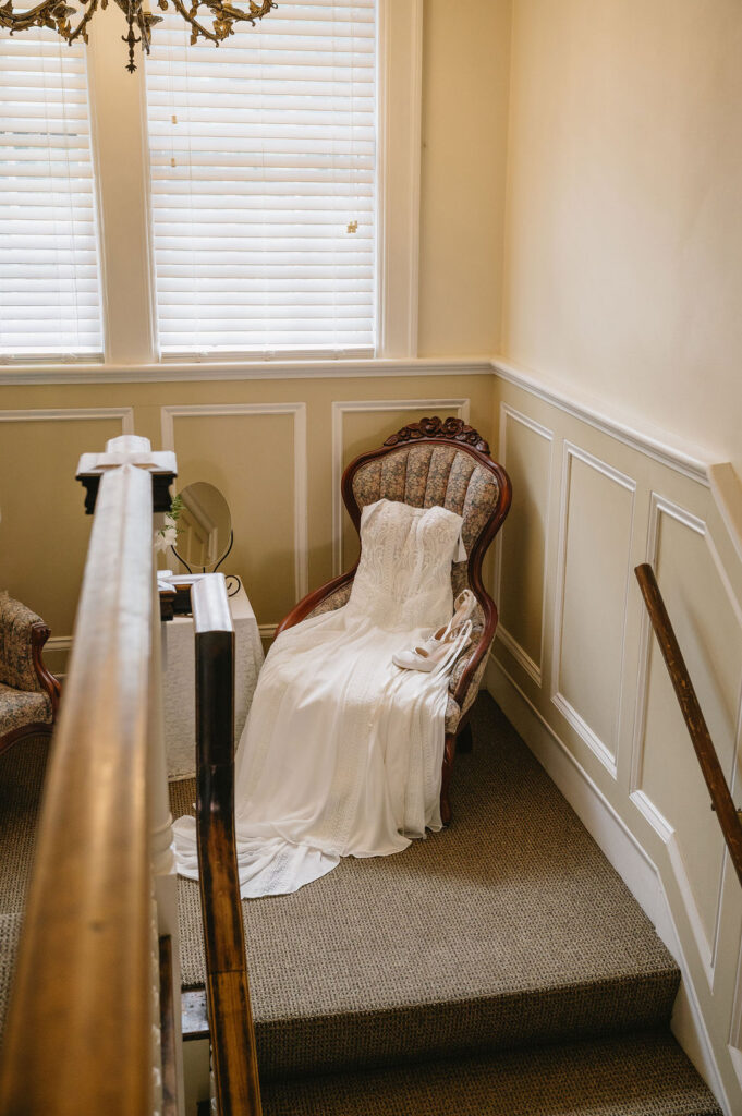 wedding gown laying on chair