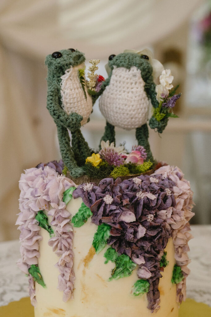 crochet frogs on top of wisteria wedding cake