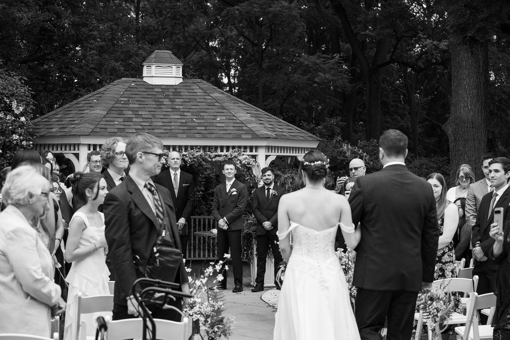 bride walking down aisle at wedding ceremony