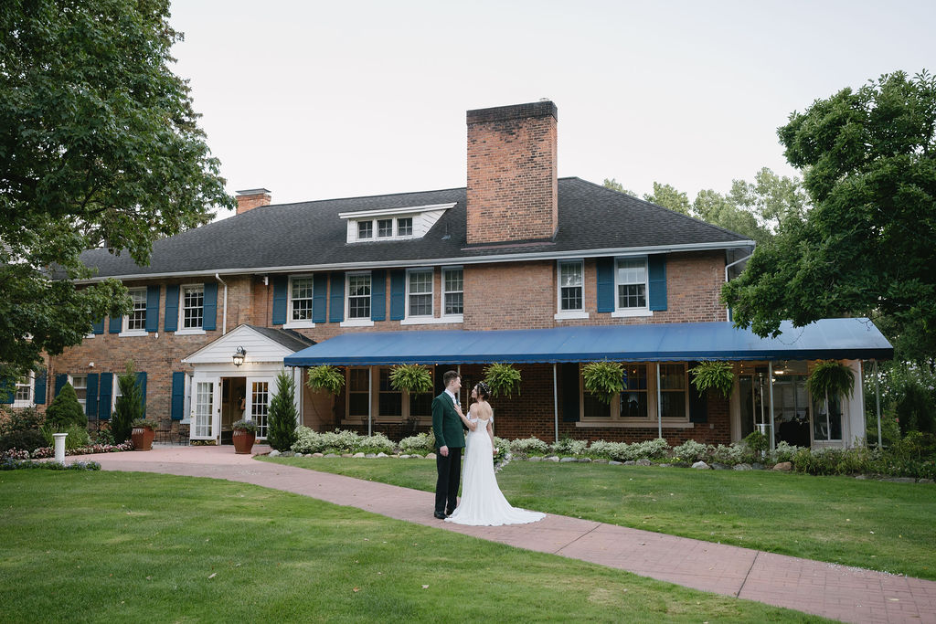 couple standing outside of longacre house
