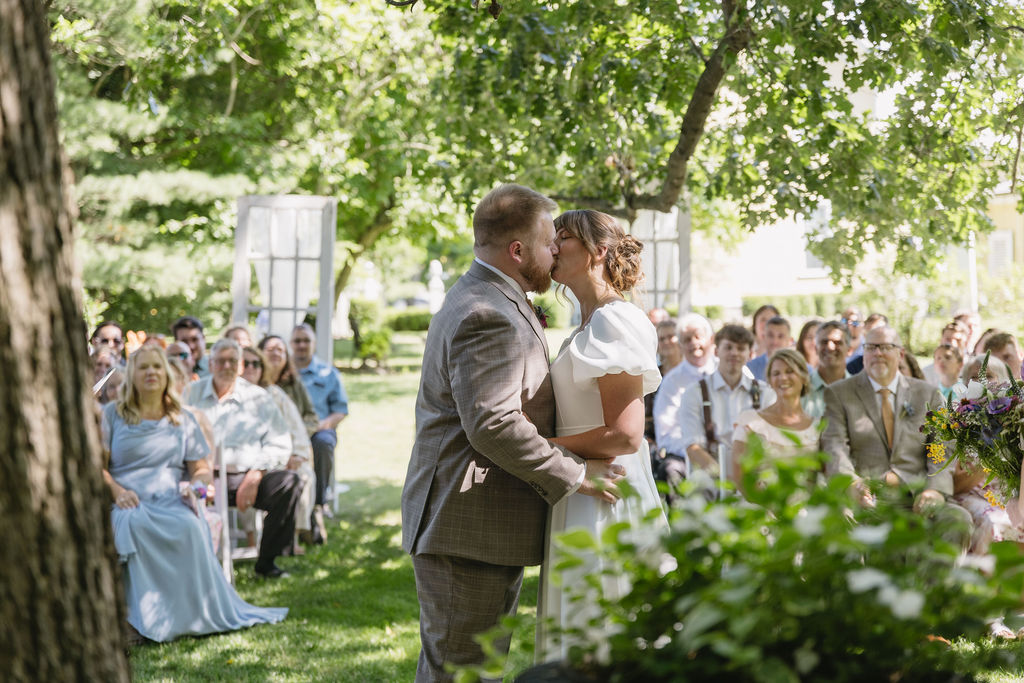 bride and groom kissing at wedding ceremony at liberty farm
