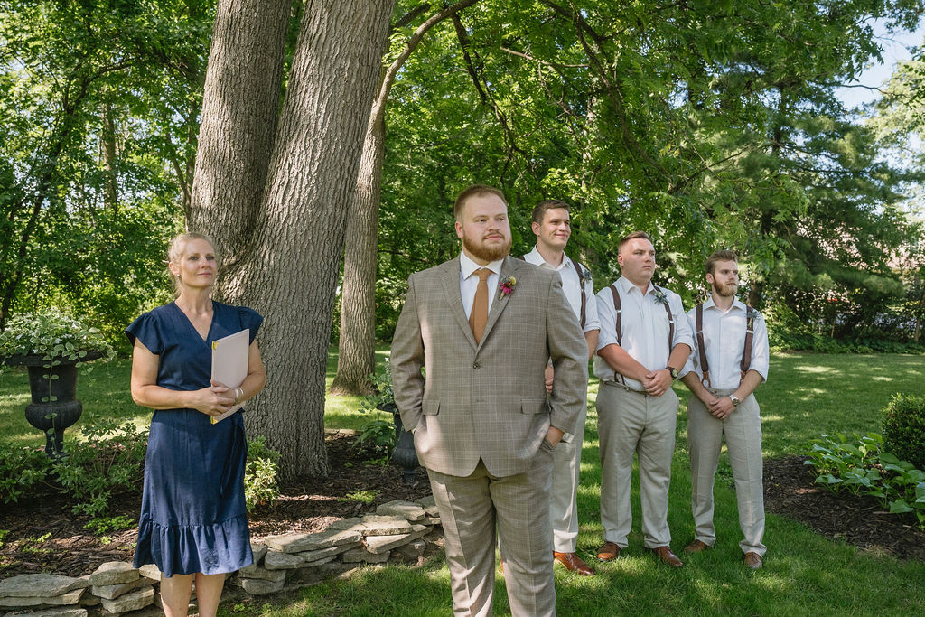 groom and groomsmen standing at ceremony