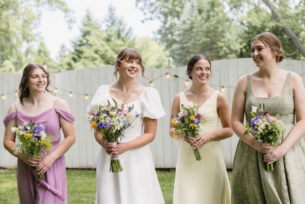 bridesmaids in pastel gowns walking