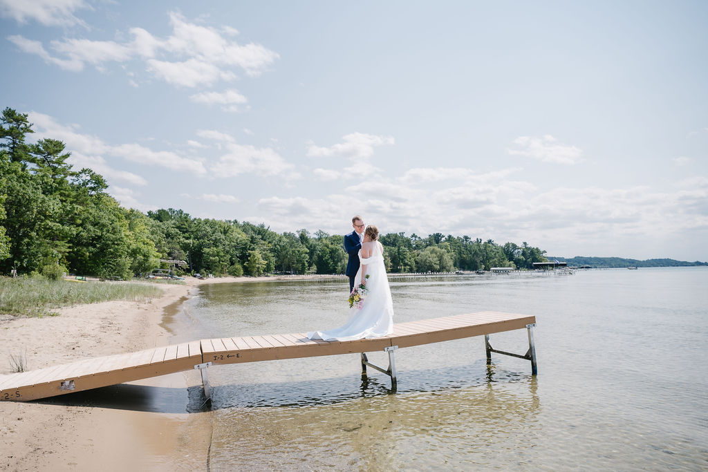 bride and groom standing on dock