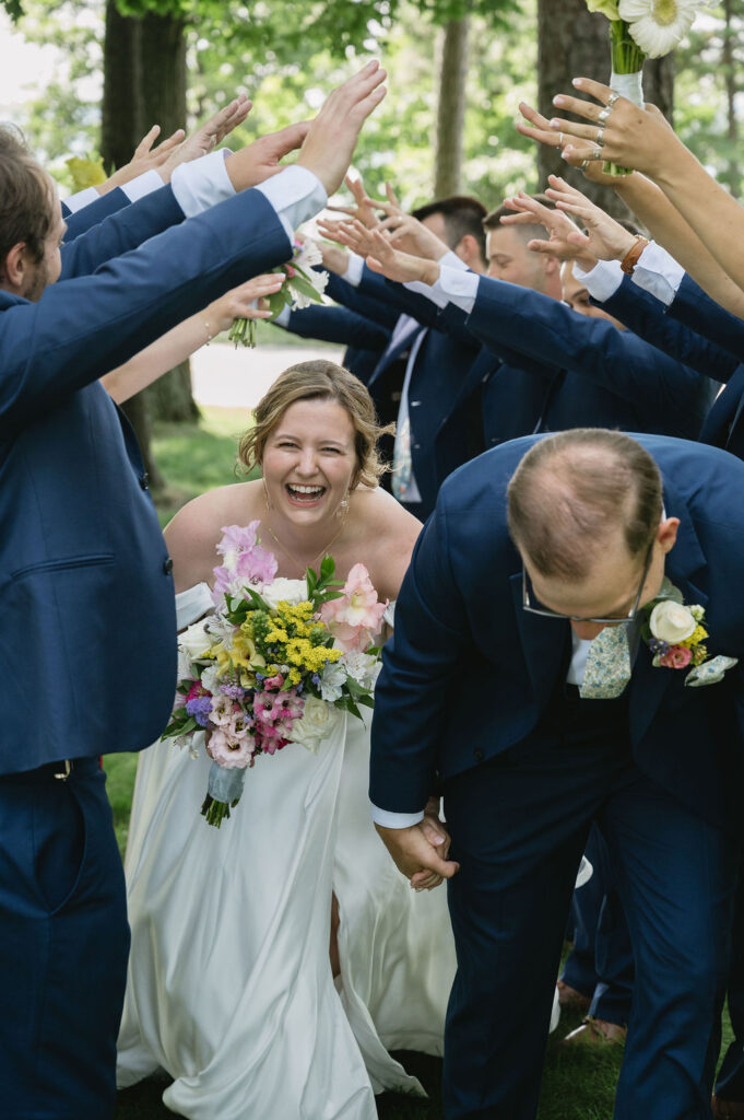 bride laughing while walking with groom