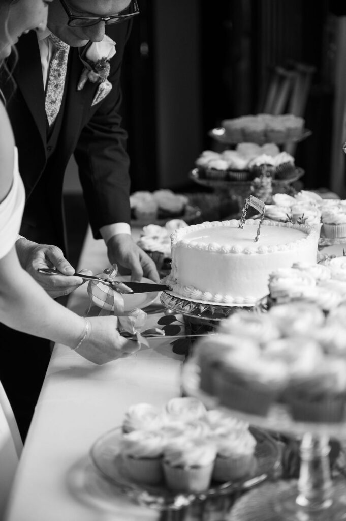 bride and groom cutting wedding cake