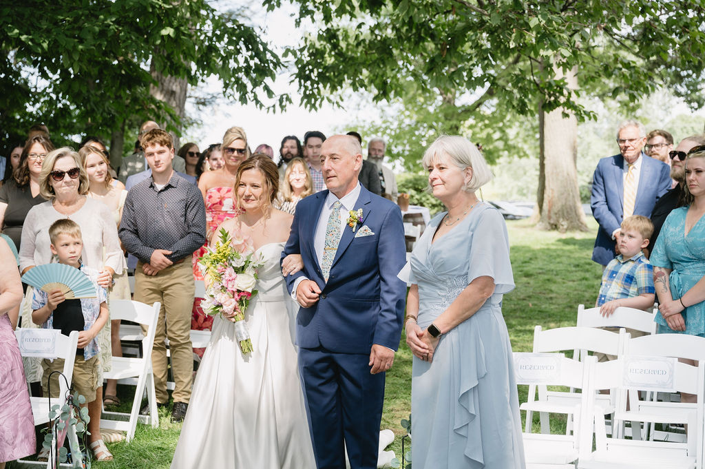 bride and her parents standing outside