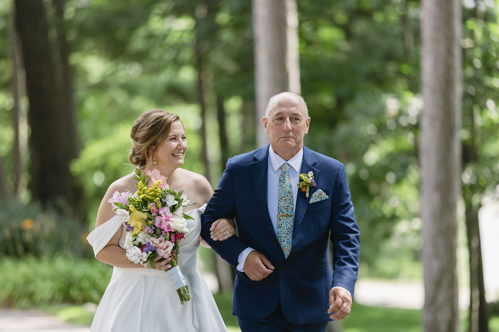 bride and father walking towards wedding ceremony