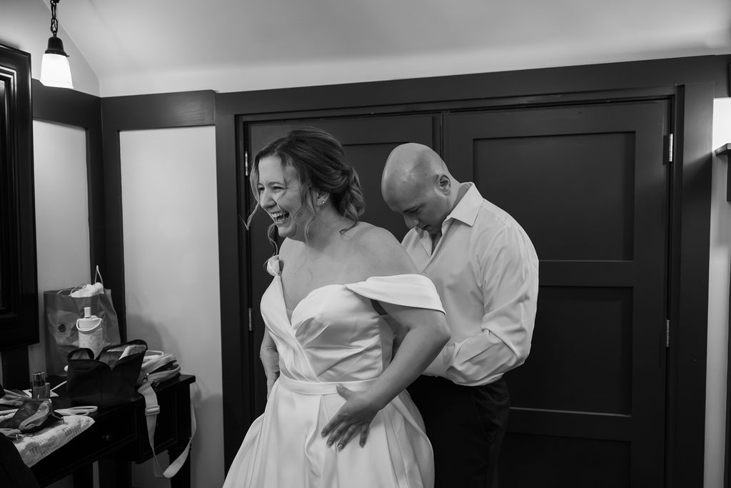 bride getting into wedding gown