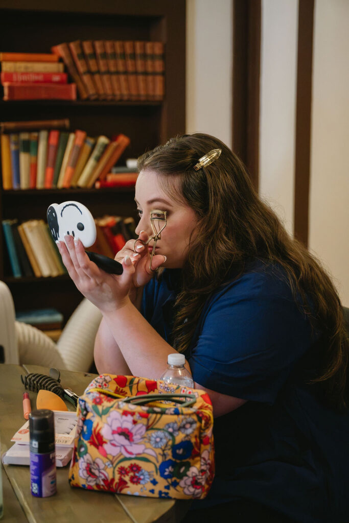 bridesmaid applying makeup